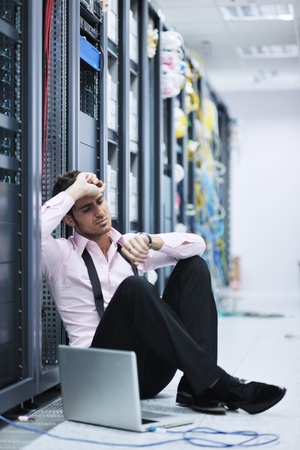young engeneer business man with thin modern aluminium laptop in network server roomの写真素材