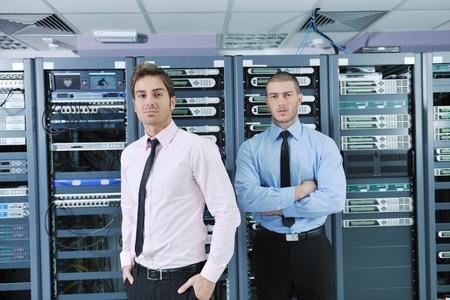 group of young business people it engineer in network server room solving problems and give help and...