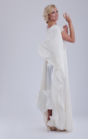 beautiful young bride wearing  wedding dress in retro fashion style isolated on white background in studioの写真素材