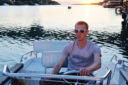happy young man have fun at boat at sunset on summer season