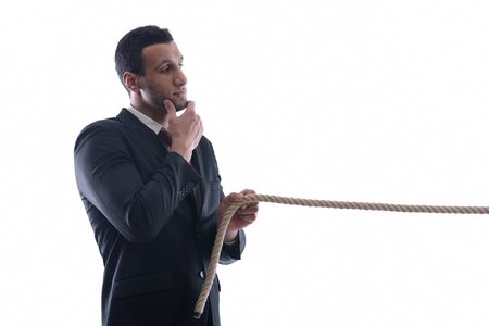 Business man with rope isolated on white backgroundの写真素材