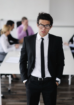 Confident young business man attending a meeting with his colleaguesの写真素材
