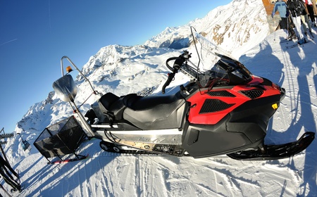 snow mobile sledge parked at mountaint top at beautiful winter sunny dayのeditorial素材