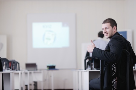 young business man giving presentation and education leassons on seminar event in small bright...