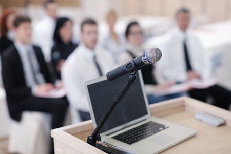 business laptop and microphotone at podium on seminar conference education