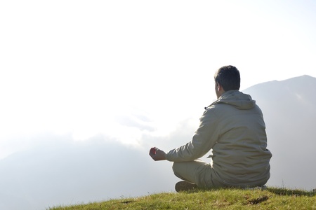 healthy young man practice yoga in height mountain at early morning and sunriseの写真素材
