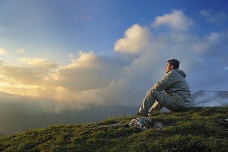 healthy young man practice yoga in height mountain at early morning and sunriseの写真素材