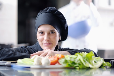 beautiful young chef woman prepare and decorating tasty food in kitchen