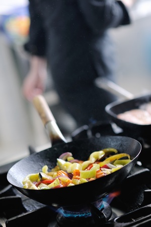 beautiful young chef woman prepare and decorating tasty food in kitchenの写真素材