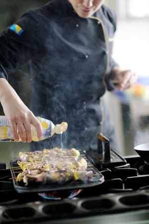 beautiful young chef woman prepare and decorating tasty food in kitchenの写真素材