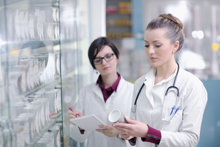 team of  pharmacist chemist woman group  standing in pharmacy drugstoreの写真素材
