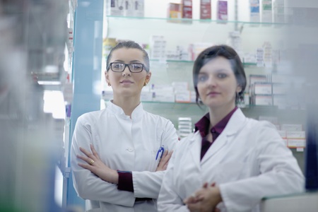 team of  pharmacist chemist woman group  standing in pharmacy drugstoreの写真素材