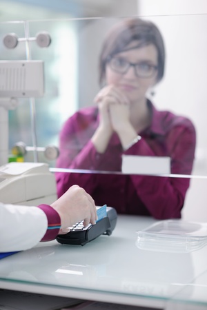young pharmacist suggesting medical drug to buyer in pharmacy drugstoreの写真素材