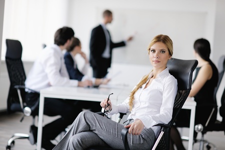 business woman  with her staff,  people group in background at modern bright office indoorsの写真素材