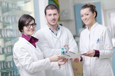 team of  pharmacist chemist woman and man  group  standing in pharmacy drugstoreの写真素材