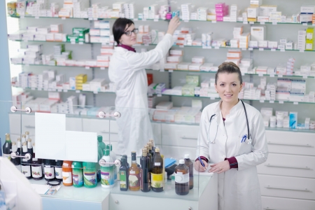 team of  pharmacist chemist woman group  standing in pharmacy drugstoreの写真素材