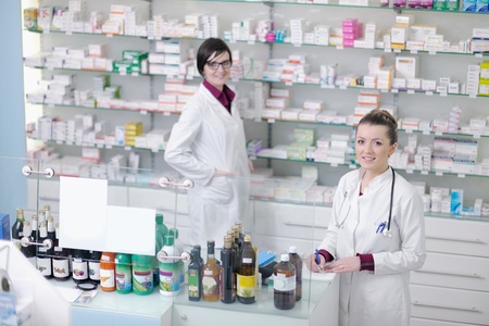 team of  pharmacist chemist woman group  standing in pharmacy drugstoreの写真素材
