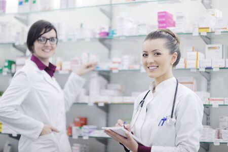 team of  pharmacist chemist woman group  standing in pharmacy drugstoreの写真素材