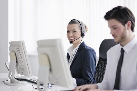 business people group with  headphones giving support in  help desk office to customers, manager giving training and education instructionsの写真素材