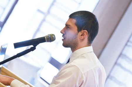 young  male business man giving a presentation at a  meeting seminar at modern conference room  on a...
