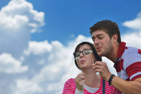 Portrait of romantic young couple in love  smiling together outdoor in nature with blue sky in backgroundの写真素材