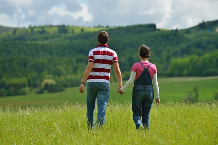 Portrait of romantic young couple in love  smiling together outdoor in nature with blue sky in backgroundの写真素材