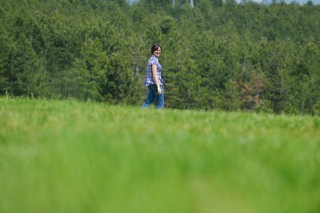 Enjoying the nature and life. Young woman arms raised enjoying the fresh air in green natureの写真素材