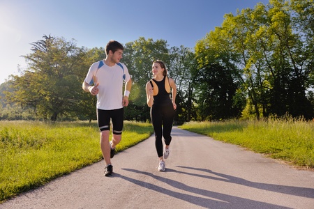 Young couple jogging in park at morning. Health and fitness.の写真素材