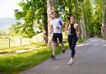 Young couple jogging in park at morning. Health and fitness.の写真素材