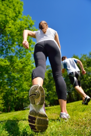 Young couple jogging in park at morning. Health and fitness.の写真素材