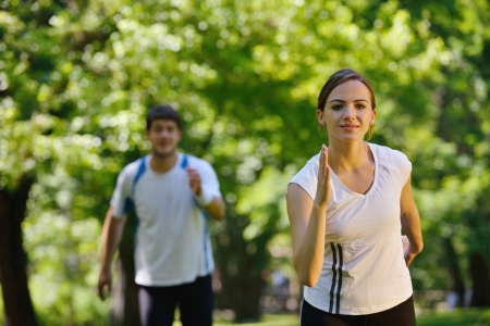 Young couple jogging in park at morning. Health and fitness.の写真素材