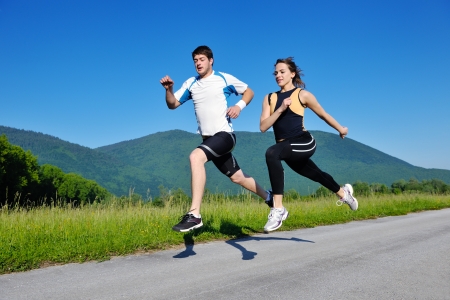 Young couple jogging in park at morning. Health and fitness.の写真素材