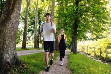Young couple jogging in park at morning. Health and fitness.の写真素材