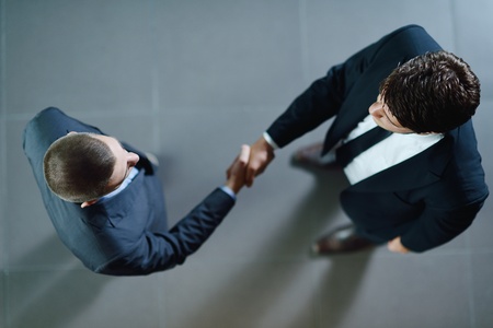 business people shaking hands make deal and sign contractの写真素材