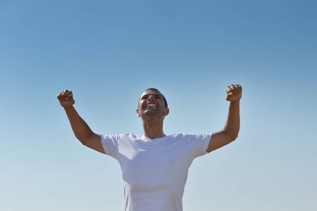 young man in wheat field representing success agriculture and freedom concept