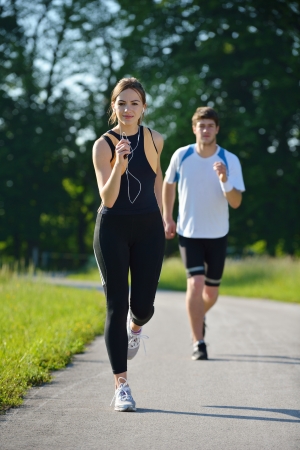 Young couple jogging in park at morning  Health and fitness conceptの写真素材