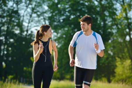 Young couple jogging in park at morning. Health and fitness conceptの写真素材