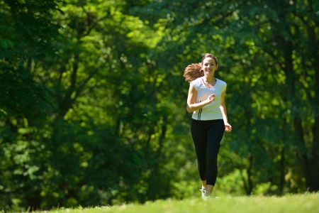 Young beautiful  woman jogging on morning at  park. Woman in sport outdoors health conceptの写真素材