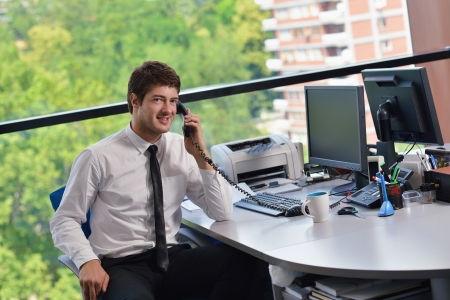 happy young business  man work in modern office on computerの写真素材