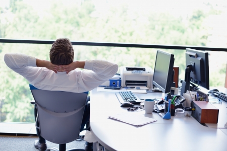 happy young business  man work in modern office on computerの写真素材