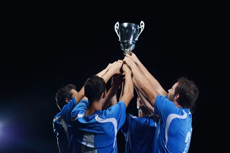 soccer players team group celebrating the victory and become champion of game while holding win coupの写真素材