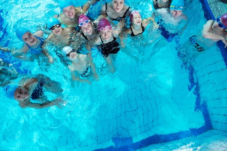 happy childrens group  at swimming pool class  learning to swimの写真素材