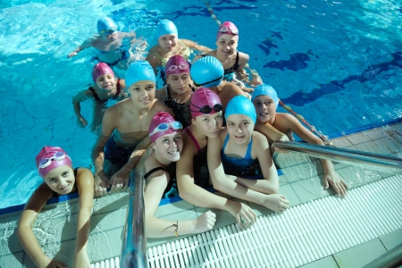 happy childrens group  at swimming pool class  learning to swimの写真素材