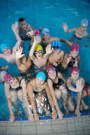 happy childrens group  at swimming pool class  learning to swimの写真素材