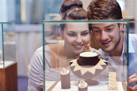 happy young romantic couple in love buy jewelry ring in luxury storeの写真素材