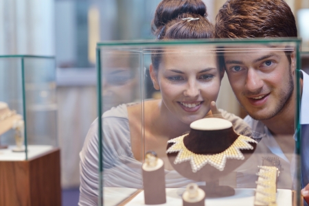 happy young romantic couple in love buy jewelry ring in luxury storeの写真素材
