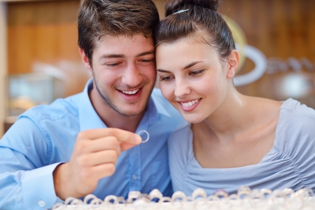 happy young romantic couple in love buy jewelry ring in luxury storeの写真素材