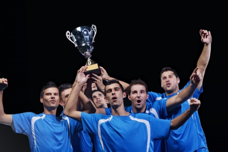 soccer players team group celebrating the victory and become champion of game while holding win coupの写真素材