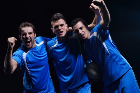 soccer players team group celebrating the victory and become champion of game while holding win coupの写真素材