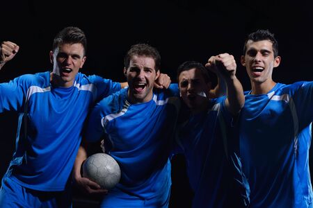 soccer players team group celebrating the victory and become champion of game while holding win coupの写真素材